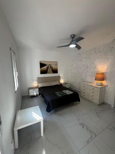 a bedroom with a bed and a table in it at A vacation by the sea in Puerto de Sagunto