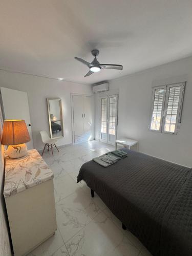 a bedroom with a bed and a ceiling fan at A vacation by the sea in Puerto de Sagunto