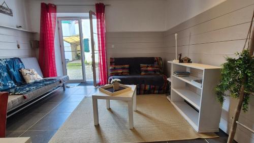 a living room with a couch and a table at Garaztegia Studio in Ustaritz