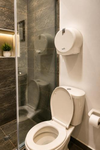 a bathroom with a toilet and a glass shower at Hotel Don Felipe in Ríohacha
