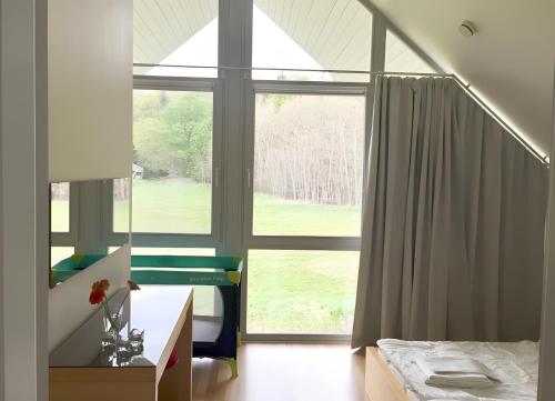 a bedroom with a bed and a large window at Haus W 7 in Röbel