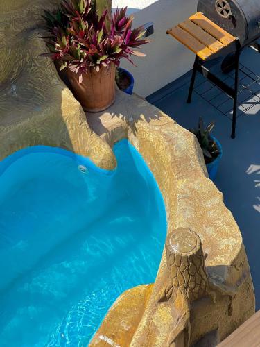 a swimming pool with a pool noodle at Ocean Breeze Guest House in Tamraght Ouzdar