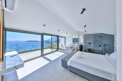 a bedroom with a bed and a view of the ocean at Villa Sky Line - Private Pool - Panoramic Sea View in Kaş