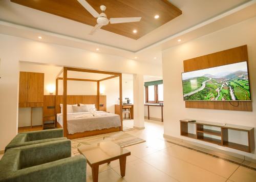a bedroom with a bed and a tv on a wall at 36 Palms- Sun and Sand in Cochin
