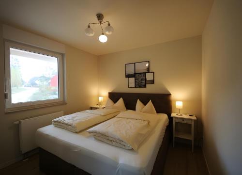 a bedroom with a large bed and a window at Roter Blitz 2 k108 in Röbel