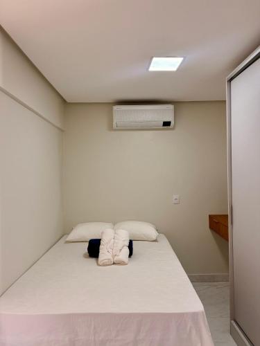 a bedroom with a large bed with a air conditioner at Tropical House Santarém in Santarém