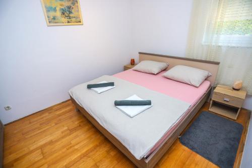 a bedroom with a large bed with pink and white sheets at Medo in Novigrad Istria