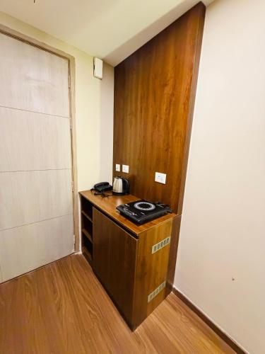 a room with a kitchen with a wooden door at Av stays in Greater Noida