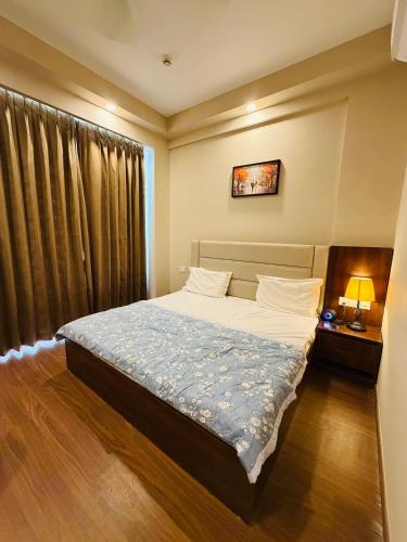 a bedroom with a bed and a window at Av stays in Greater Noida
