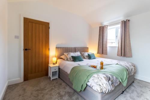 a bedroom with a large bed and a window at The Stables in Sibbertoft