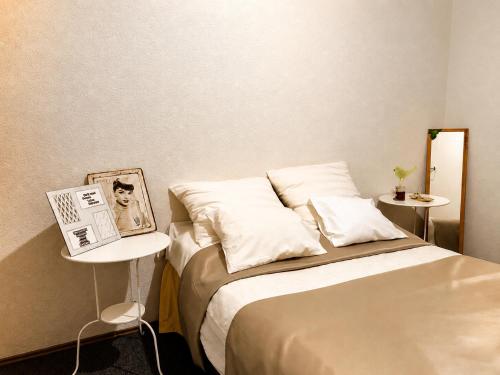 a bedroom with a bed and a side table at Holiday Home Kotulin in Pakoštane