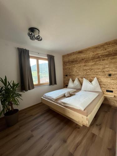 a bedroom with a large bed with a wooden headboard at Haus Anneliese in Gröbming