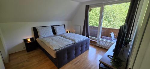a bedroom with a bed and a large window at Zimnitzblick in Haiden