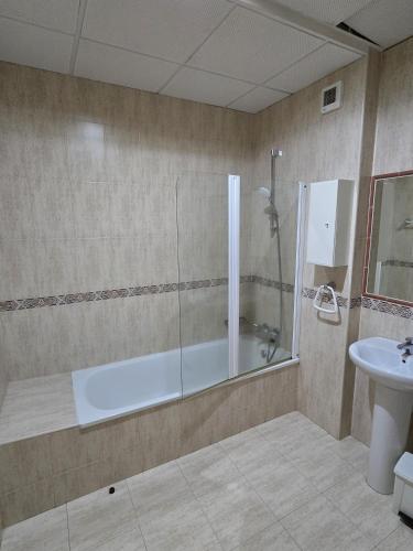 a bathroom with a shower and a sink at Hostal La Cigüeña in El Espinar