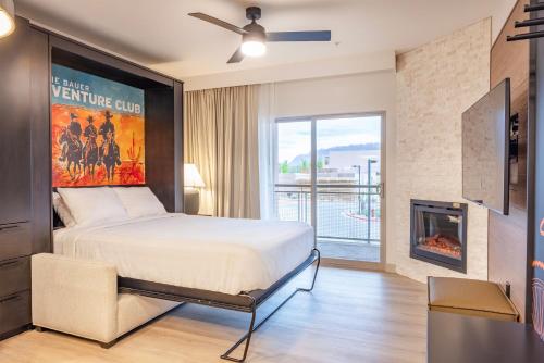 a bedroom with a bed and a fireplace at EBAC Moab in Moab