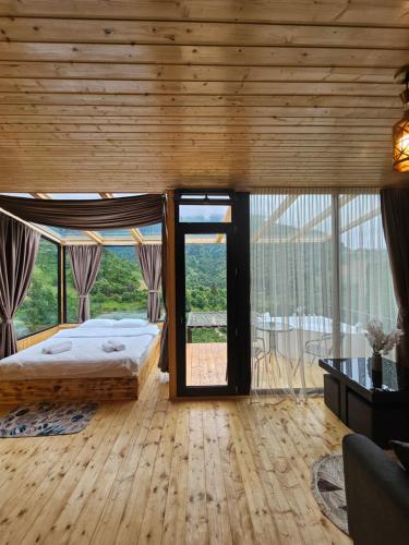 a bedroom with a bed and a large window at Merisi Horizon 2 in Silibauri