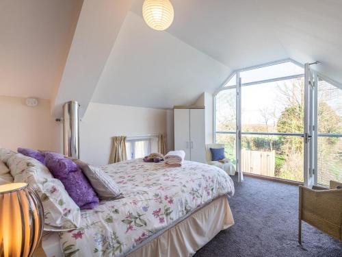a bedroom with a bed and a large window at 4 Bed in Holsworthy oc-77663 in Milton Damerel