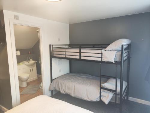 two bunk beds in a room with a bathroom at Fairfield in Felton