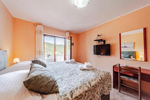 a bedroom with a bed and a mirror and a television at Villa Castello in Korčula