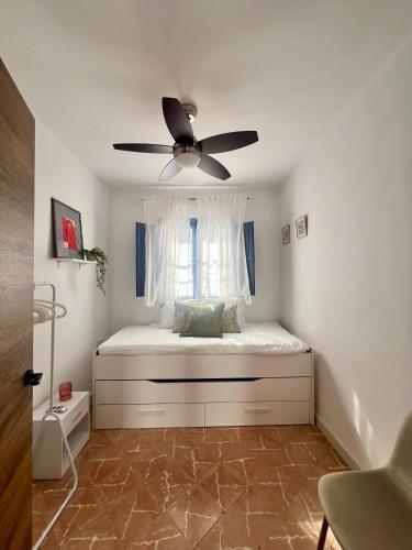 a bedroom with a bed with a ceiling fan at Patio del recuerdo in Benalup Casas Viejas