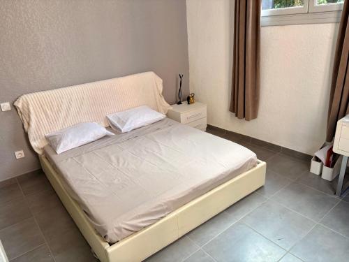 a bedroom with a bed with two pillows on it at Appartements Corte centre in Corte