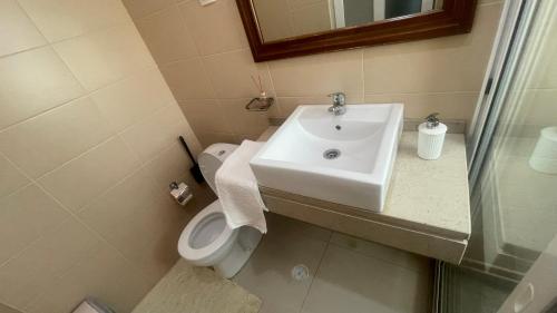 a bathroom with a sink and a toilet at Residencial FSFA in Praia