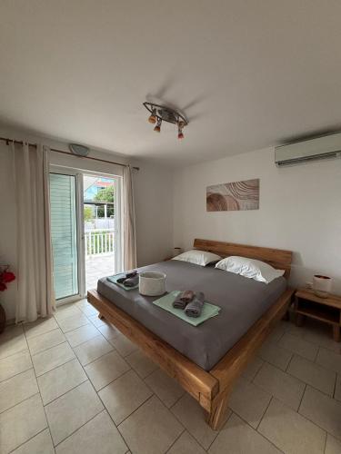 a bedroom with a bed and a large window at Foissner Apartments in Zavalatica