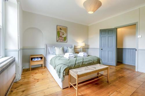 a bedroom with a bed and a table in it at 3 Bed in Northrepps oc-k29801 in Cromer