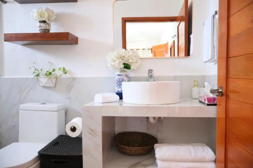 a bathroom with a sink and a mirror at Casa Velamar in Isla Mujeres