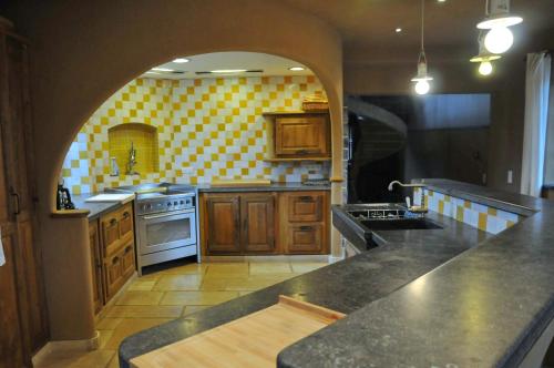 a kitchen with an archway in the middle of it at Château-ferme de Pondrome in Beauraing