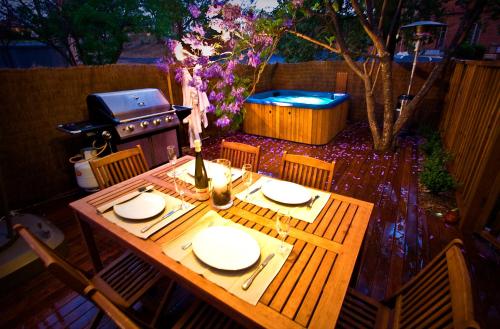 a wooden table with plates and a grill in a backyard at Old Parkes Convent in Parkes