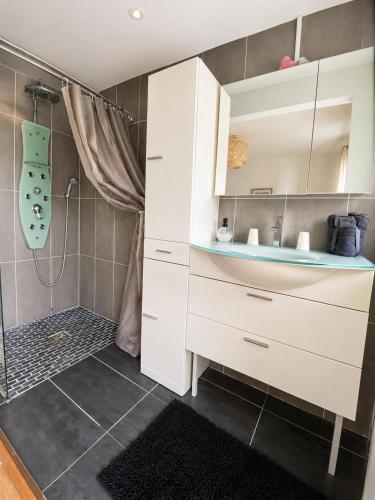 a bathroom with a sink and a shower at La parenthèse in Calais