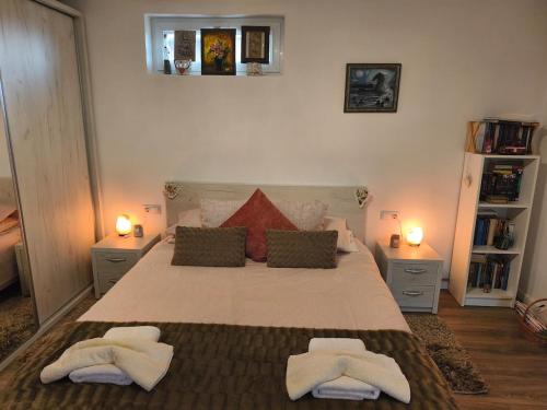 a bedroom with a large bed with two towels on it at Casa Luna in Călimăneşti