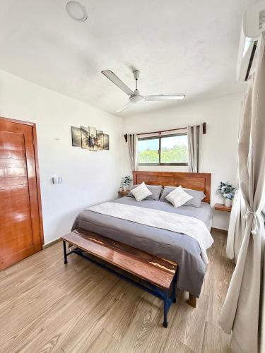 a bedroom with a large bed and a window at Casa Velamar in Isla Mujeres