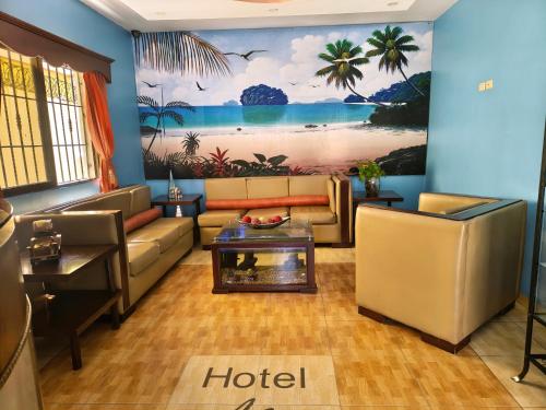 a living room with couches and a painting on the wall at Hotel La Morada in Santo Domingo