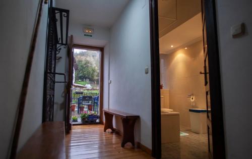 a hallway with a staircase leading to a bathroom with a window at Posada de Labaien in Beinza-Labayen