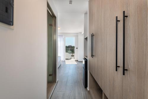 a hallway with a wooden wall with a mirror at Pantheon Hotel in Kefalos