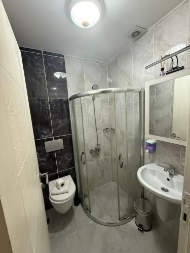a bathroom with a shower and a toilet and a sink at Şişli Suites - Room48 in Istanbul