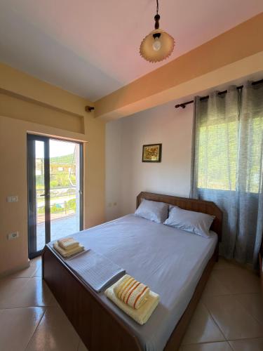 a bedroom with a large bed with a window at Moliana Bunec in Himare