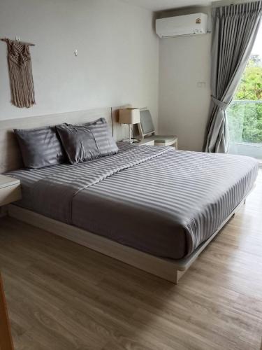 a bedroom with a large bed in a room at Le Grand Bleu in Koh Samui