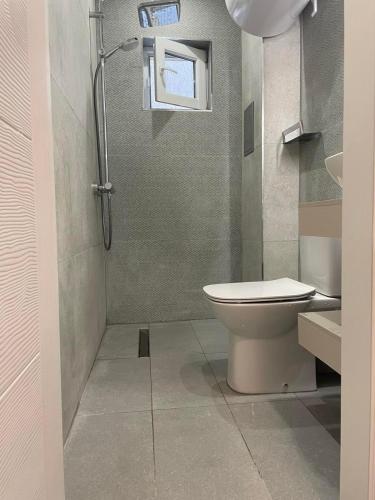a bathroom with a toilet and a shower at Medoni Summer Hive in Sozopol