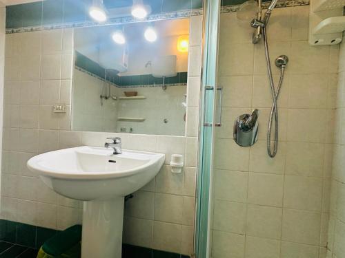 a bathroom with a sink and a shower at Salsedine - Immobilevante in Ponza