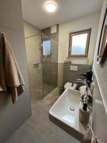 a bathroom with a sink and a shower at Haus Anneliese in Gröbming