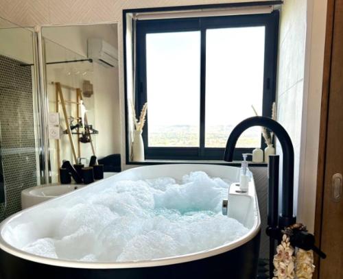 a bath tub filled with snow in a bathroom at Studio cosy avec balnéo et climatisation in Albi
