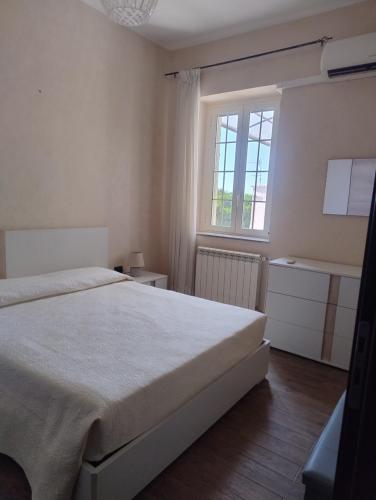 a bedroom with a large bed and a window at B&B Vista Mare in Palmi