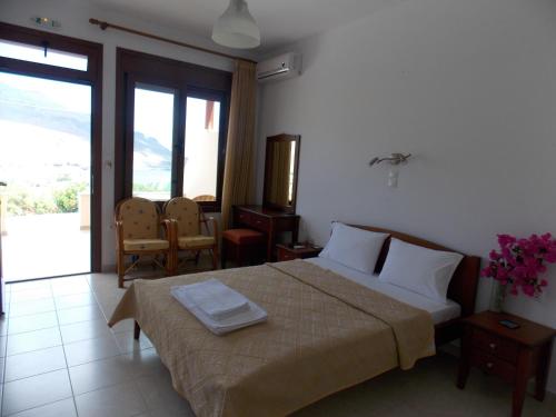 Ένα ή περισσότερα κρεβάτια σε δωμάτιο στο Kato Zakros Palace Apartments