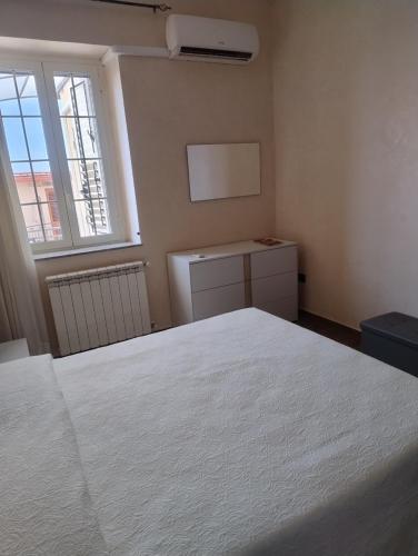 a bedroom with a white bed and a window at B&B Vista Mare in Palmi