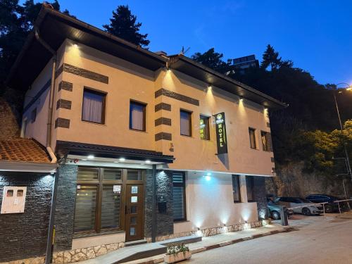 a building with a sign on the front of it at HOTEL PERLA - Free Parking in Sarajevo