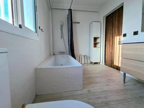 a white bathroom with a tub in a room at Alma Andaluza Apart 1 in Mairena del Aljarafe