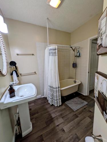 a bathroom with a sink and a bath tub at Hook Wine and Sinker in Marion